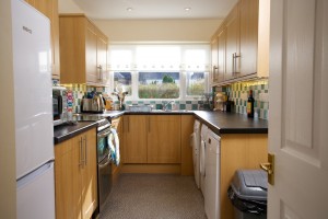 Photo of kitchen showing cupboards and appliances