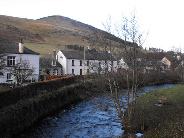 Photograph taken from the Cuddy Bridge in Innerleithen, Scottish Borders, with the Leithen Water, some cottages and Lee Pen in the background