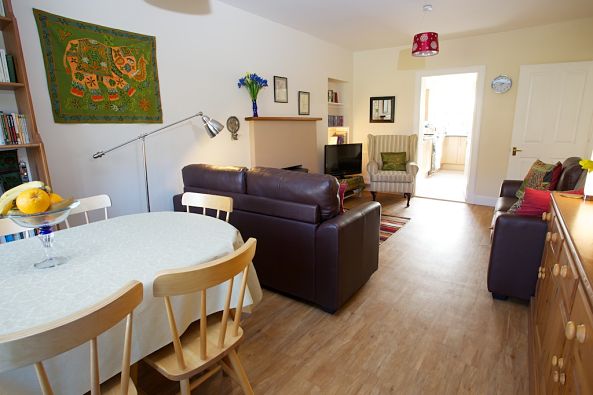 Photo of living room showing dining table, looking through to kitchen at Cosaig Self-Catering Innerleithen